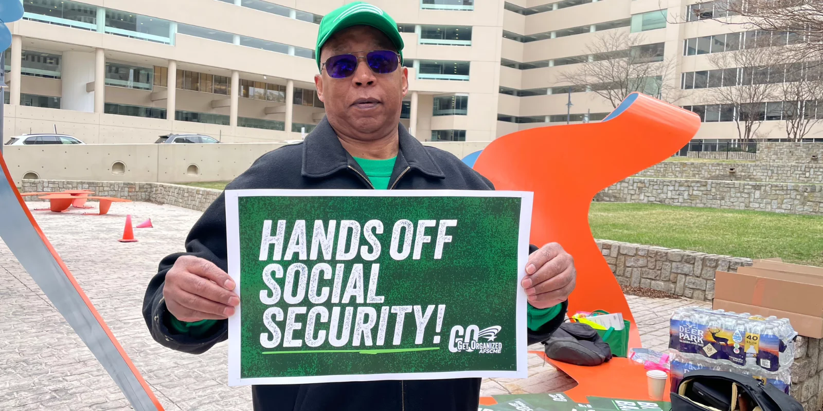 Member holding sign