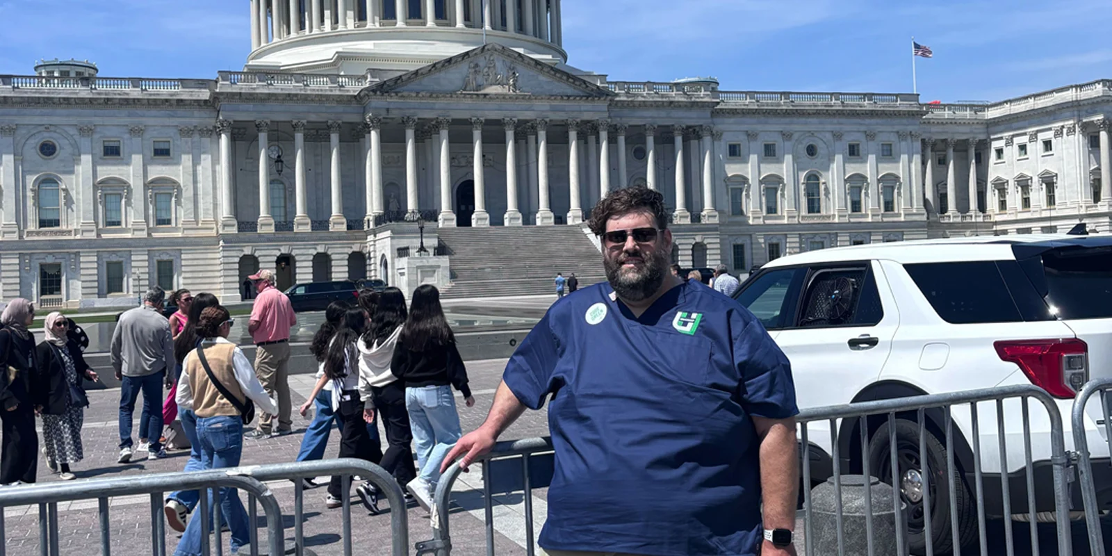 Member in front of capitol