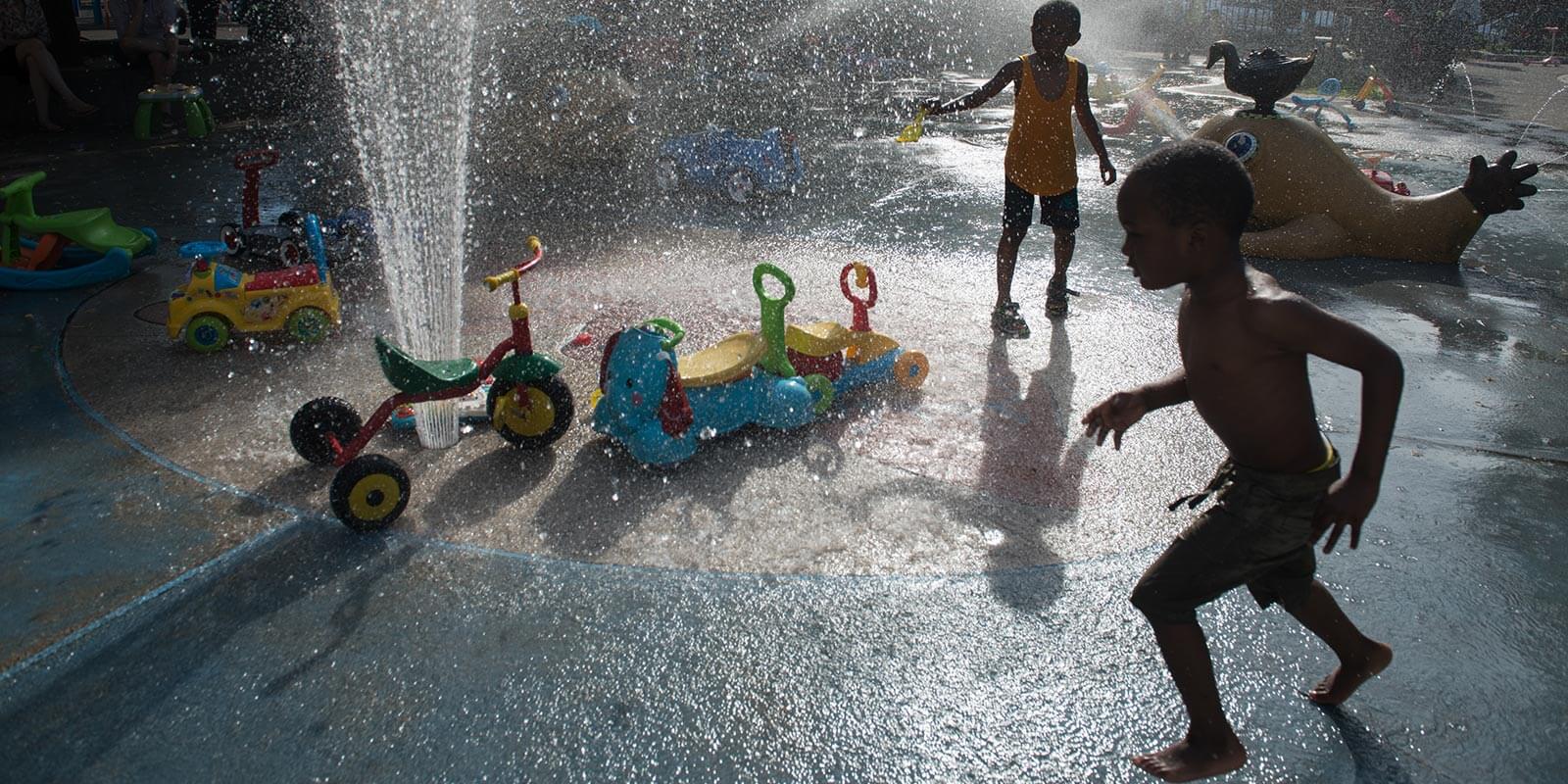 Kids playing in sprinklers