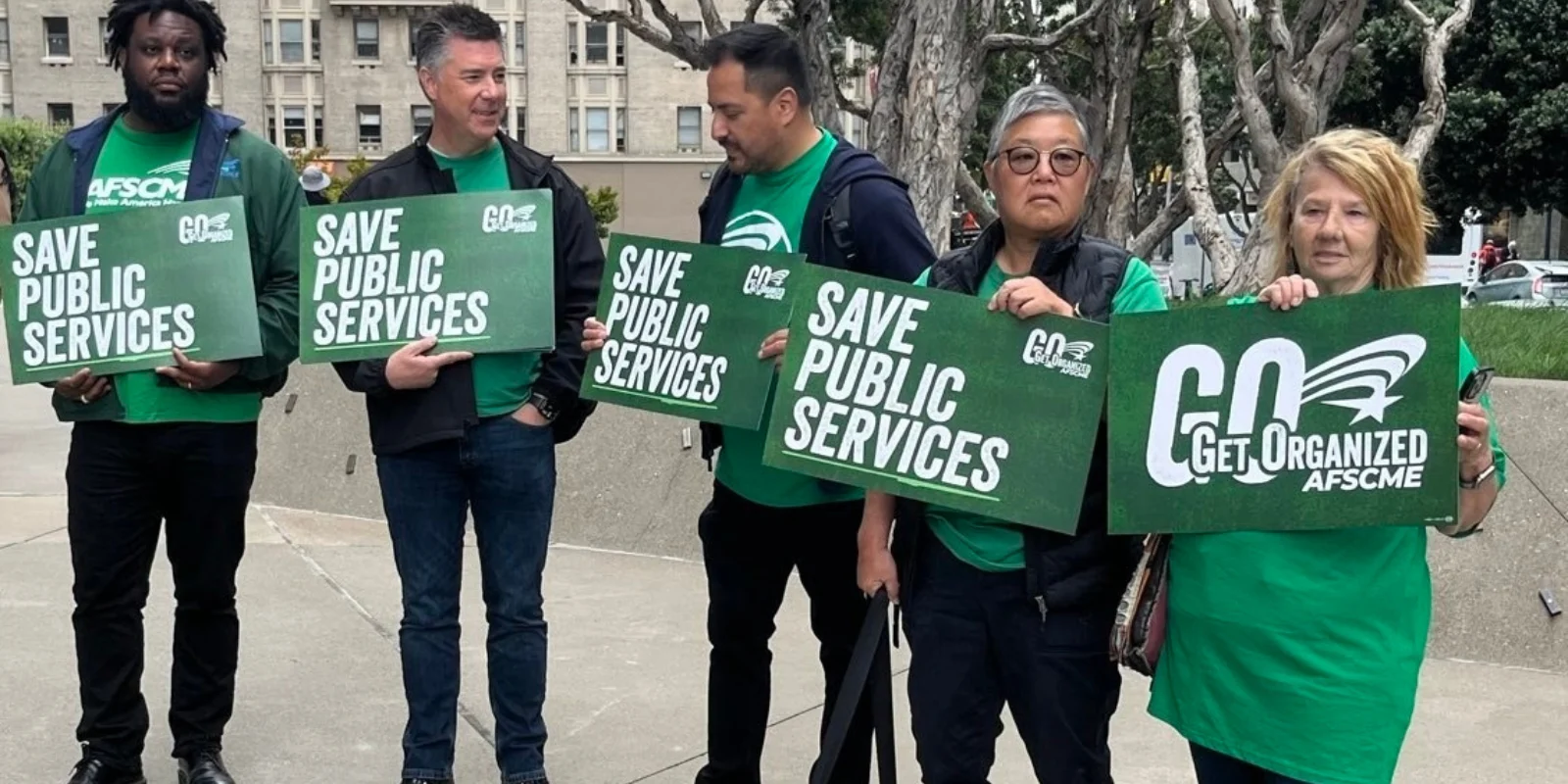 Members gather with signs