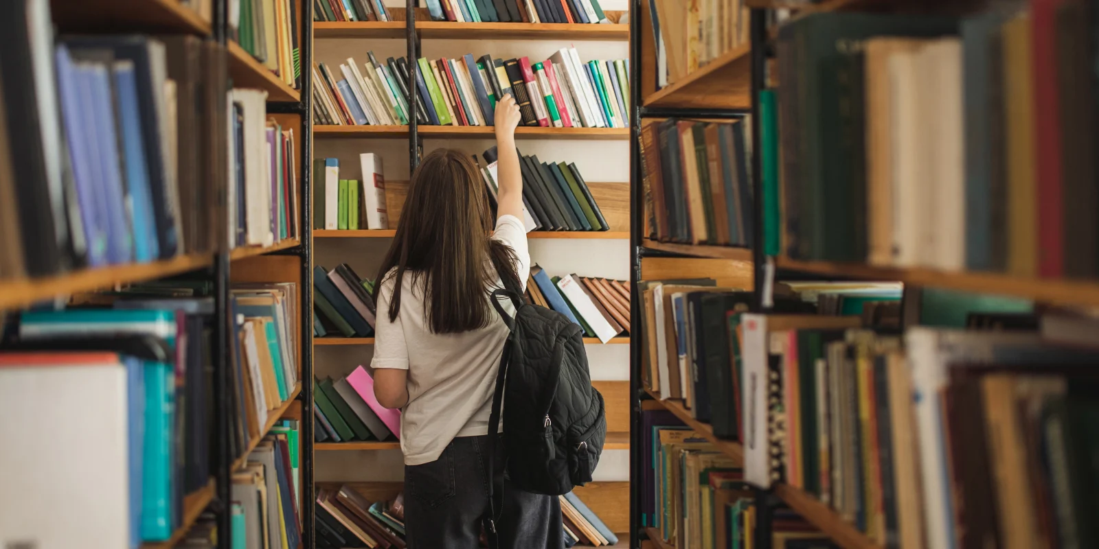 Person reaching for library book