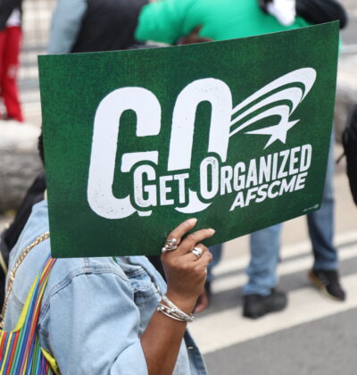 Woman hold Get Organized sign