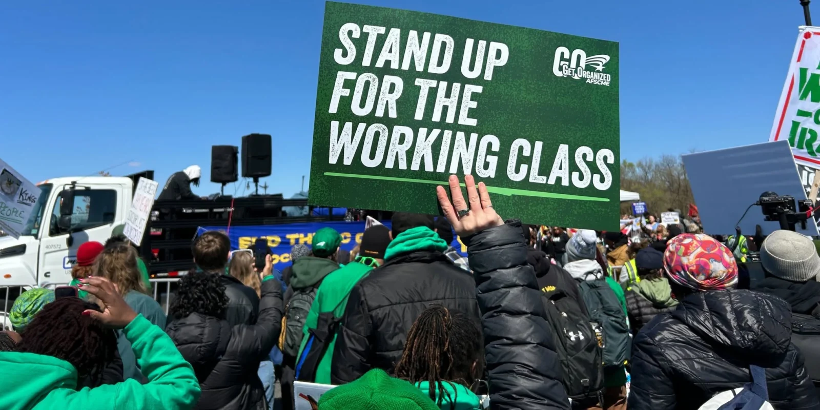 Sign with Stand Up for the Working Class written on it